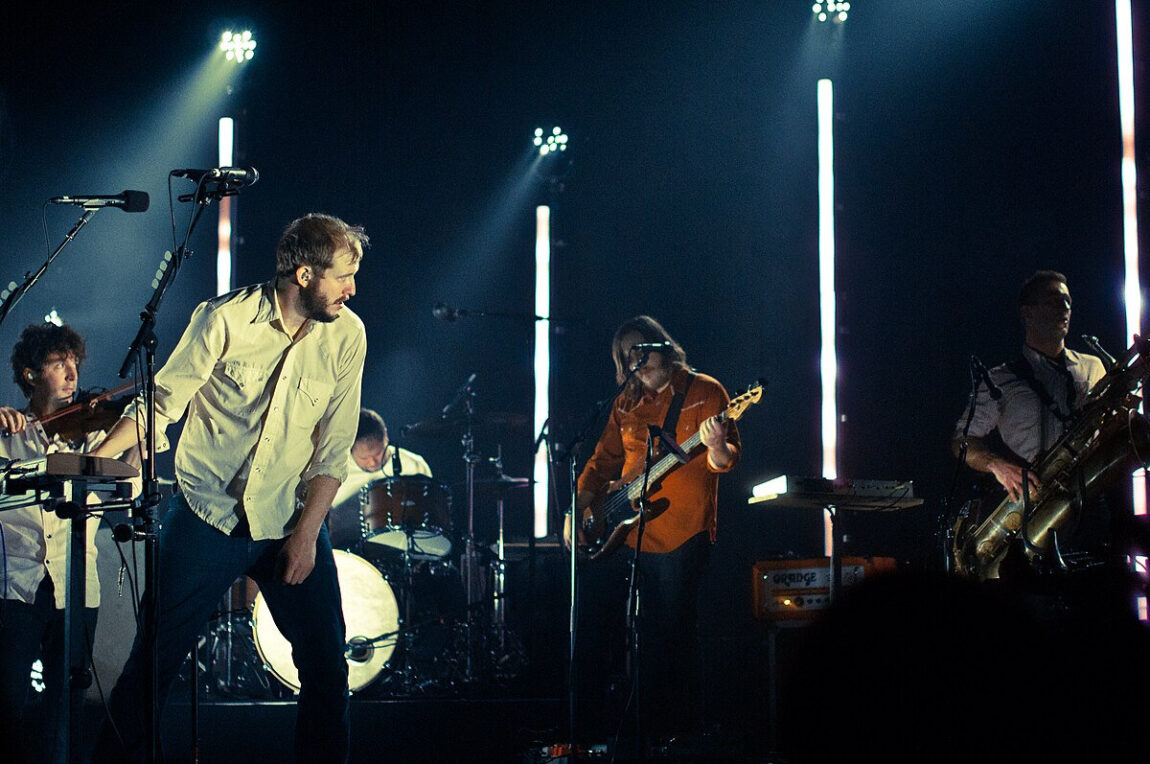 Bon Iver performs live under bright vertical lights in Stockholm.