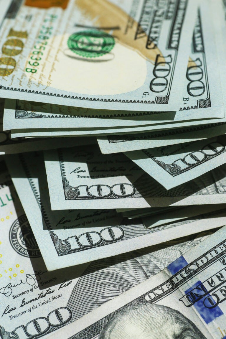 Stack of 100-dollar bills, prominently showing the number 